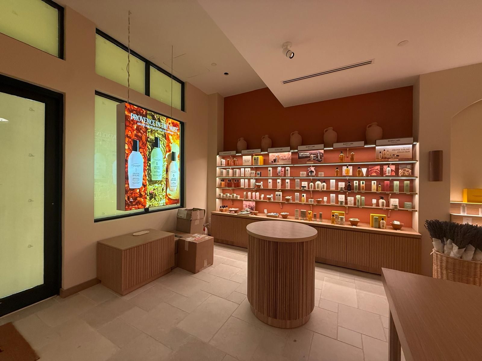 Backlit product wall, window lightbox, and accent lighting at the new L'Occitane Southlake store