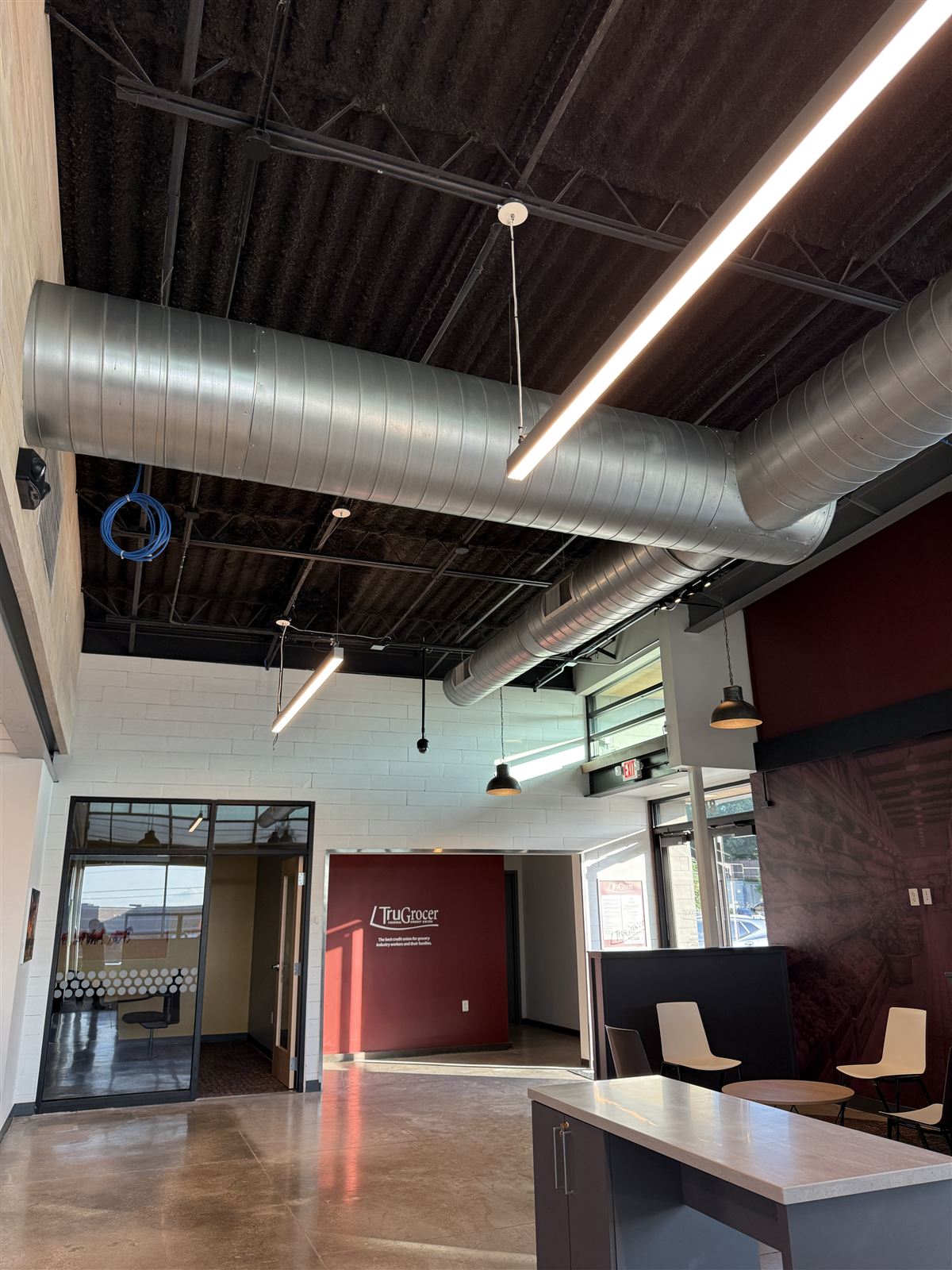 Finished TruGrocer Federal Credit Union lobby with exposed spiral ductwork installed by Phanton Mechanical