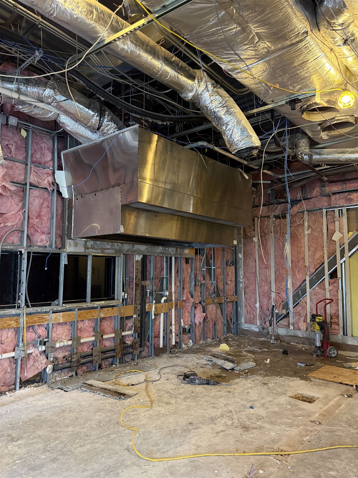 Mechanical rough-in at the TruGrocer branch — insulated ductwork, plenums, and framing before finishes