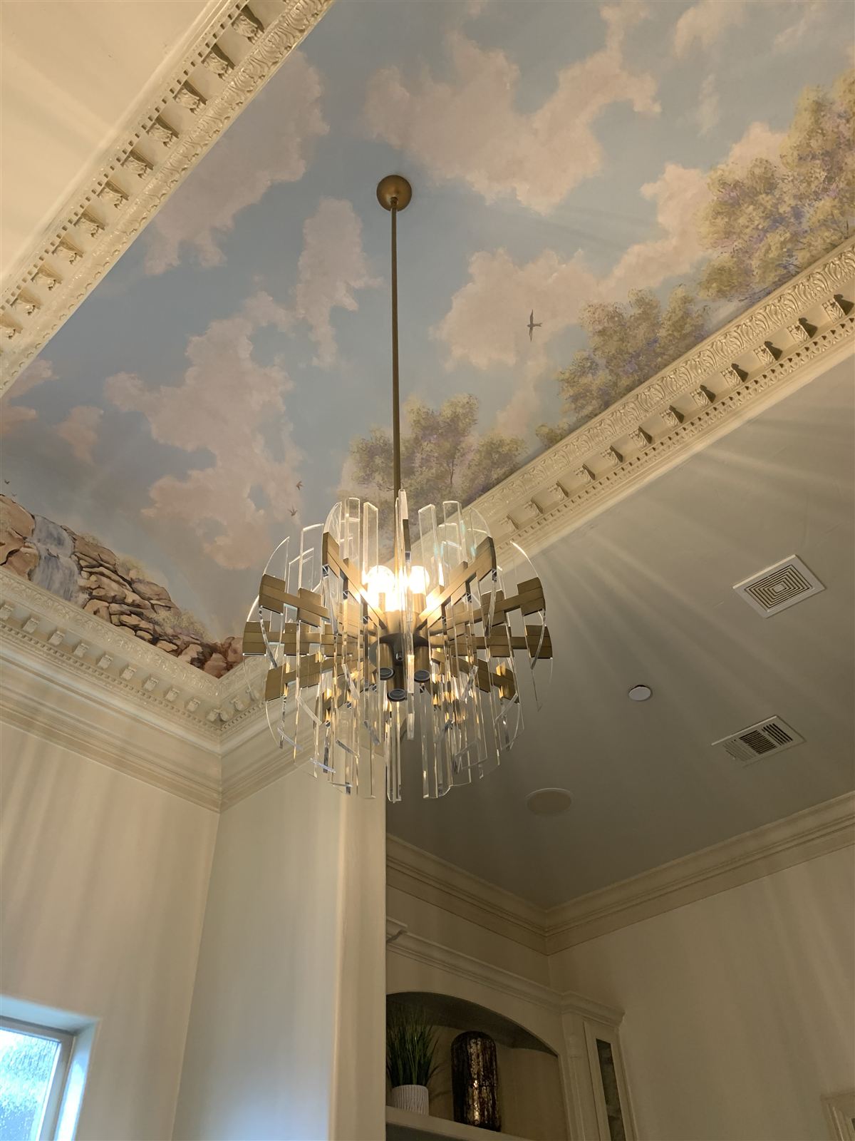 Finished luxury interior with designer chandelier, ceiling diffuser, and return grille integrated into a hand-painted ceiling