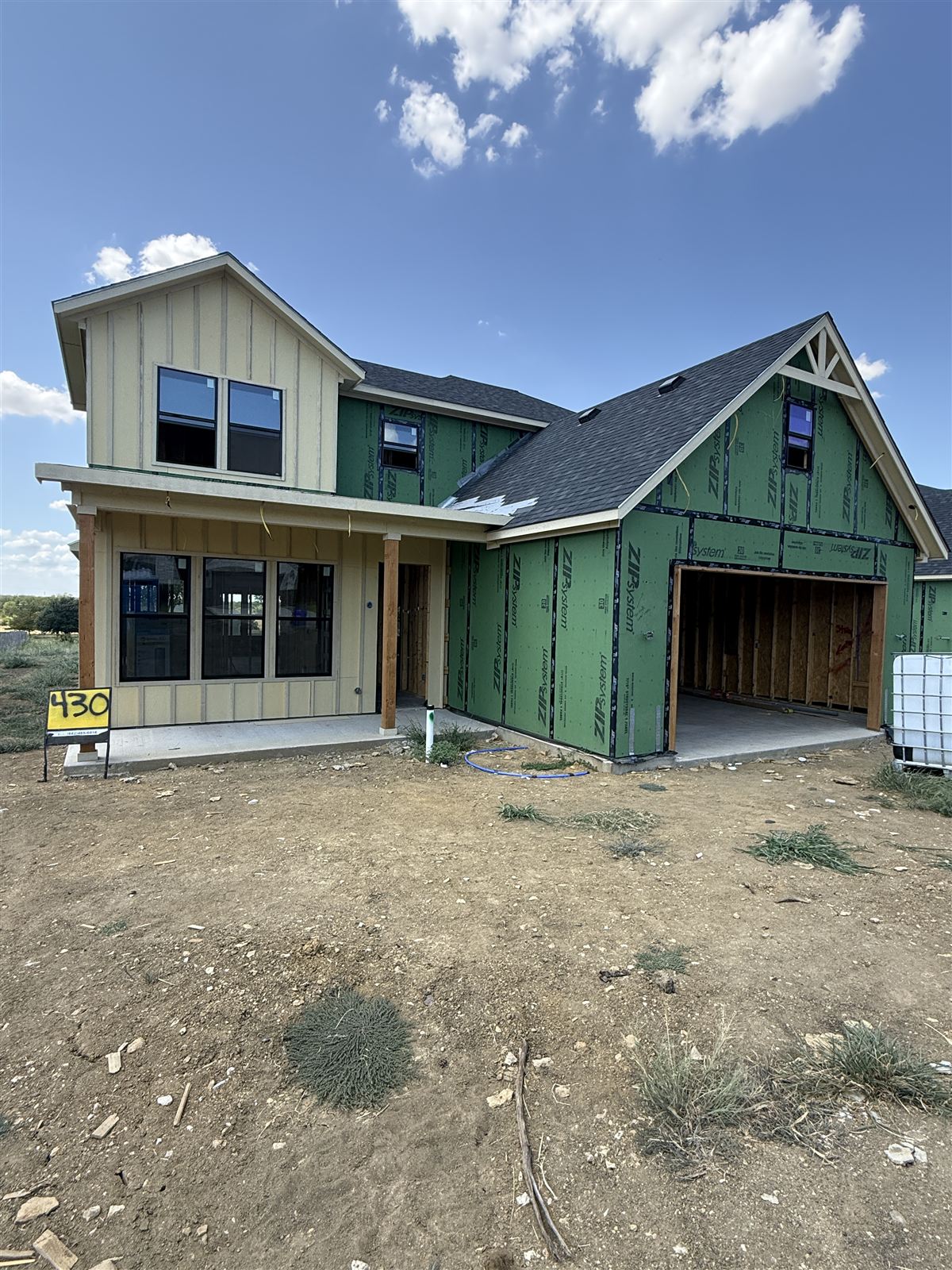 New-construction DFW home at rough-in stage with mechanical and electrical trades under way
