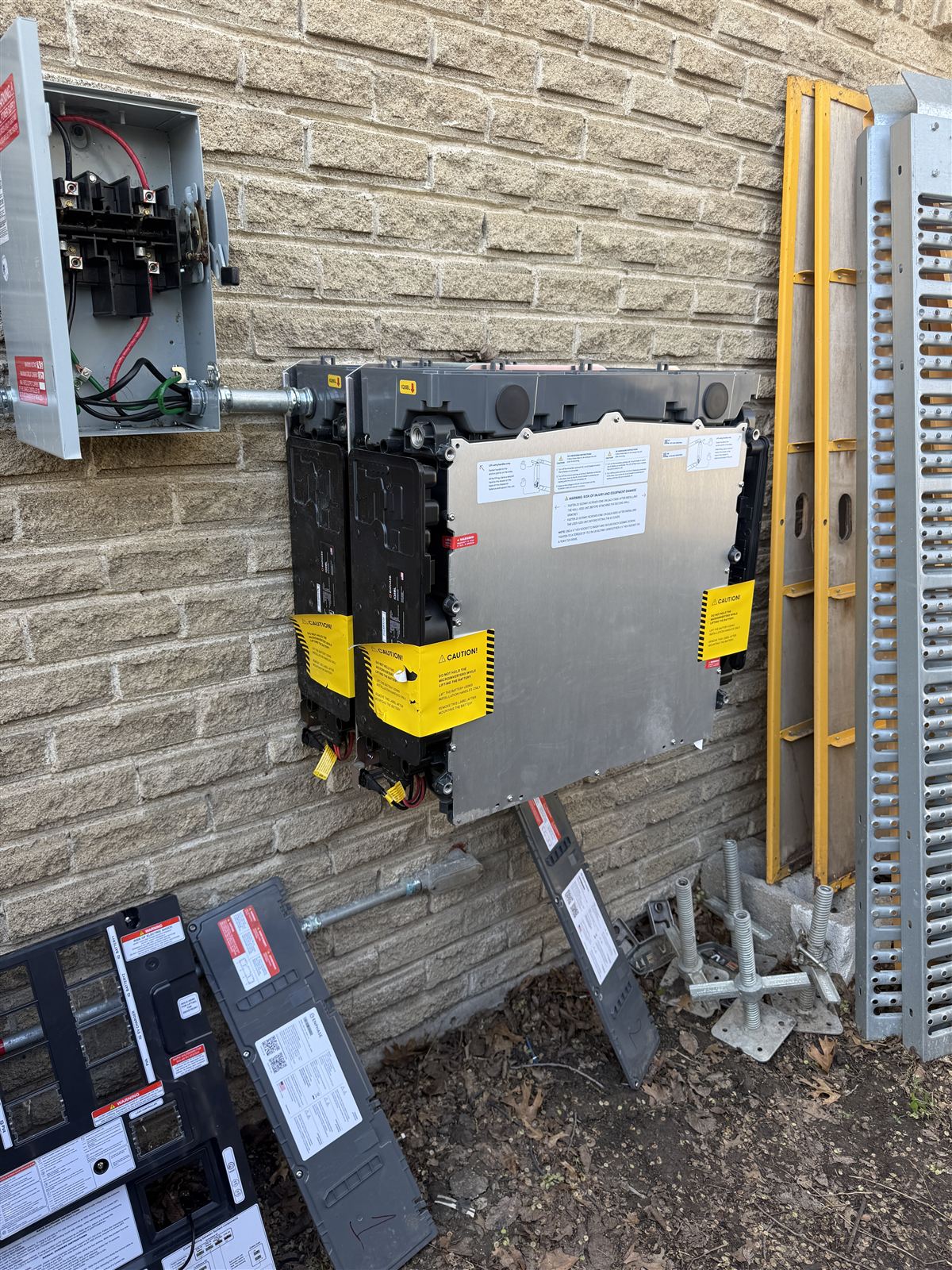 Enphase IQ Battery units staged with mounting hardware during a home energy storage installation